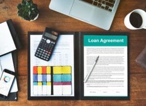 Loan agreement and financial tools on desk
